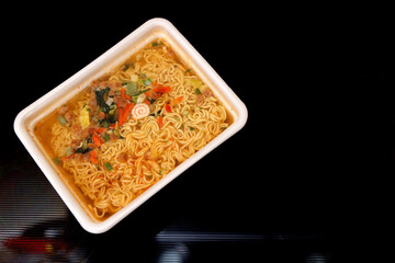 Instant noodles. Close-up. The dark background. copy space