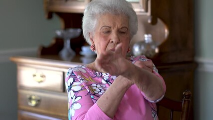 POV concept of elderly caucasian woman engaged in a video conference with her doctor via a telehealth or doctor on demand app on her wireless mobile device.