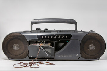 Old tape recorder on a light background. Concept of the 80s or 90s