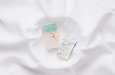 Natural soap on white linen fabric. view from above