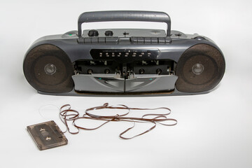 Old tape recorder on a light background. Concept of the 80s or 90s