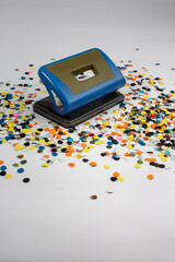 Closeup view of a group of paper punch and small black one hole puncher machine isolated on white...