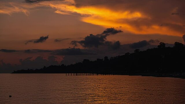 Beautiful colorful Timelapse sunset at the sea. Sun go down, orange clouds flow in sky. Lovely beauty world, travel, holidays, recreation. Majestic Time laps of sunset summer on background of seascape