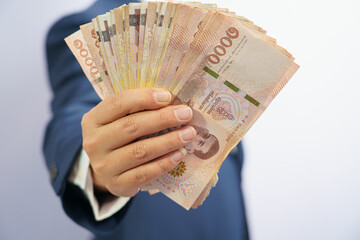Money in thailand hold on hand business man grabbing wearing a blue suit, Filed and put and give to...