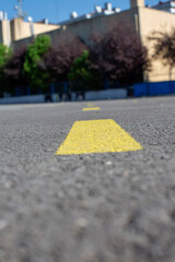 Roads separated by yellow lines, car parks separated by yellow lines