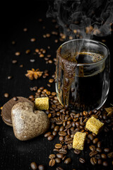 Fototapeta na wymiar Black freshly aromatic coffee. Breakfast with coffee. Black background. Close up