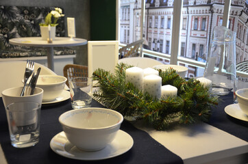 a table in a cafe is decorated for celebrating the new year or christmas. Friends Meeting In Cafe Restaurant