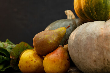 Pumpkins and pears on wooden table close-up