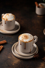 Hot winter cappuccino with cinnamon and caramel