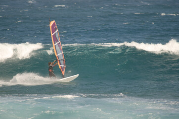 Windsurfer sailing in the coast of Arinaga. Aguimes. Gran Canaria. Canary Islands. Spain.