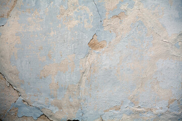 The texture of a plaster cracked wall. Stucco material, surface, background.