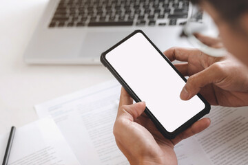 Business people holding white screen mobile phone at office desk.