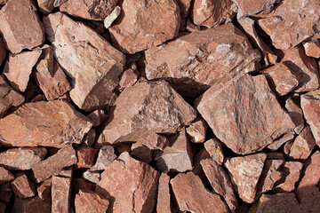 Coarse crushed stone from rock for road construction. Background, material, texture.