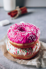  Bright colored donuts on the table close-up, vertical photo