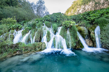 Close up view of blue waterfalls in a green forest during daytime in Summer.Plitvice lakes, Croatia