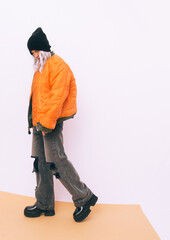 Sexy blonde model in fashion urban street look. Trendy orange bomber and stylish platform boots....