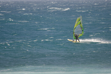 Windsurfer sailing in the coast of Arinaga. Aguimes. Gran Canaria. Canary Islands. Spain.