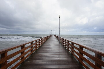 Naklejka premium pier after rain on the baltic sea. fall