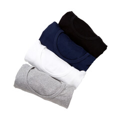 White, grey, blue and black color T-shirts rolled group on background