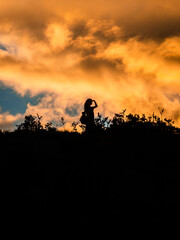 Fototapeta na wymiar Woman shadow in a awesome sunset looking ahead