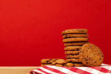 Chocolate chip cookies in stack on red background