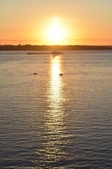 Obraz premium cargo ship sails at dawn on the Volga