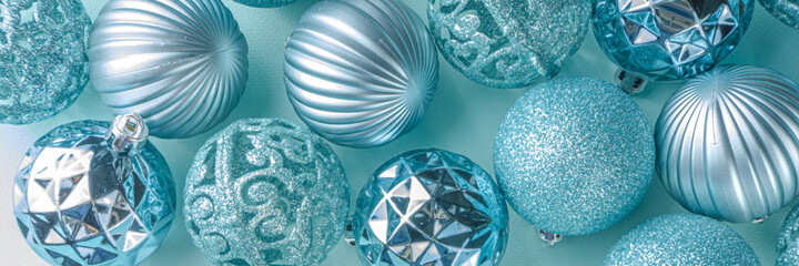 Christmas Festive Banner, Background. Monochrome Flat-lay with various blue Christmas Decoration Balls over light blue background, top view copy space, simple pattern