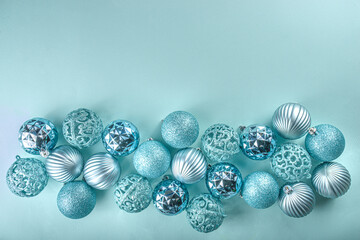 Christmas Festive Banner, Background. Monochrome Flat-lay with various blue Christmas Decoration Balls over light blue background, top view copy space, simple pattern