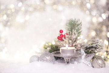 Fototapeta na wymiar Christmas decoration with candles, fir branch and balls on snow