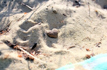 A small figure of a heart in the sand