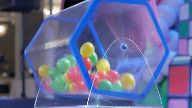 Plastic balls are mixed in a bingo drum. the drawing of prizes using a Lotto.