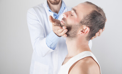 Fototapeta premium Caucasian doctor massaging patient head.