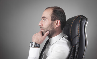 Caucasian thinking man sitting in office.