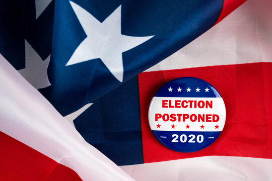 Election Postponed 2020 Text On Usa Theme Button. American National Flag In Background.