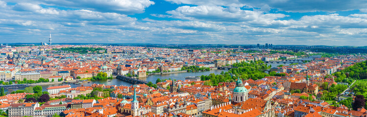 Naklejka na ściany i meble Panorama of Prague city. Aerial panoramic view of Prague Old Town historical centre, Charles Bridge Karluv Most across Vltava river and Mala Strana Town with red tiled roof buildings, Czech Republic