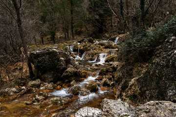 stream, stream, flowing between the rocks and stones in an autumn landscape