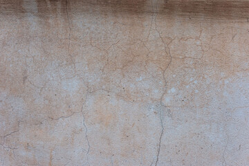 texture of brown old plaster on the street wall of the house. Warm shades