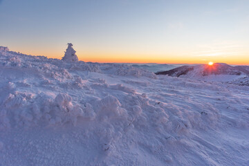 Fototapeta na wymiar Frosty snowy winter on a mountain range in the evening in the Ukrainian Carpathians