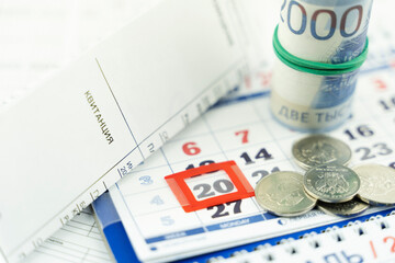 Fototapeta premium a receipt for the utilities in the background of the calendar. the concept of higher taxes for utilities translation of 
