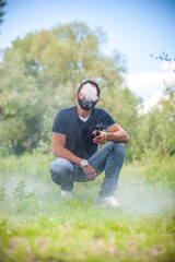 Handsome vape man releases a cloud of steam. Alternative to smoking.