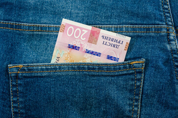 200 hryvnia in the pocket of blue jeans. Close-up.
