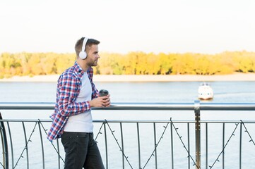 good morning drink. unshaven guy with coffee cup outdoor. male casual hipster fashion. man in...