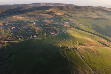 drone picture over some hills at golden hour