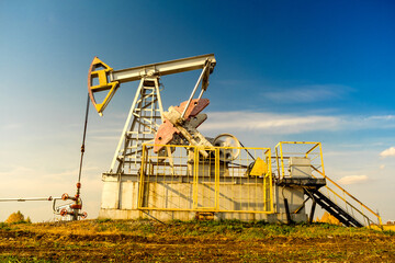 Fototapeta na wymiar Oil rigs-rocking on the oil field near the road. Oil rig. Oil industry equipment.