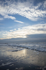 Sea, waves and beach. North sea coast. Julianadorp. Netherlands. Clouds. 