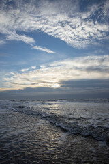Sea, waves and beach. North sea coast. Julianadorp. Netherlands. Clouds. 
