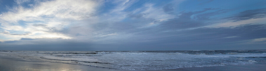 Fototapeta na wymiar Sea, waves and beach. North sea coast. Julianadorp. Netherlands. Panorama.