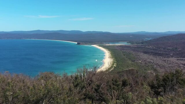 2020 - An excellent aerial view looming from a forest to Disaster Bay Lookout at Ben Boyd National Park in New South Wales, Australia.