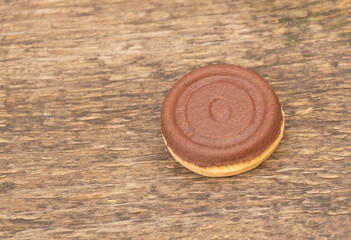 Three flavors in a single biscuit, two sides and a delicious cream in the middle. On wooden background