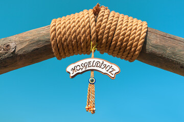 Hosgelziniz in Turkish means welcome and traditional amulet from the evil eye. Concept of a hotel...